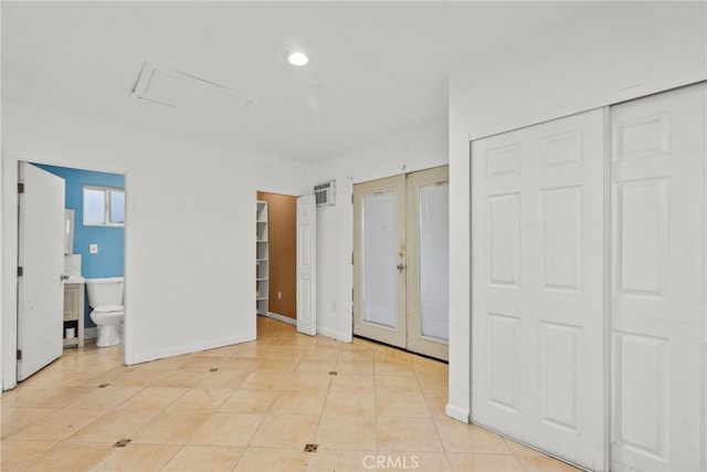 15430 Parthenia St, North Hills, CA 91343 - unfurnished bedroom featuring ensuite bathroom, attic access, light tile patterned floors, french doors, and visible vents