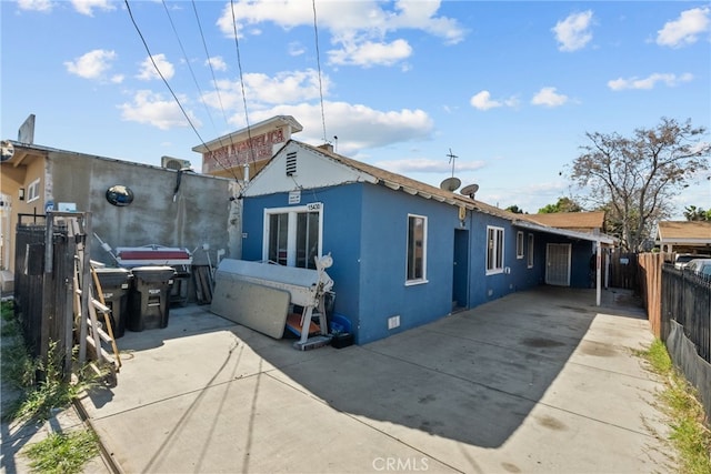 15430 Parthenia St, North Hills, CA 91343 - rear view of property featuring concrete driveway, fence, crawl space, a patio, and stucco siding