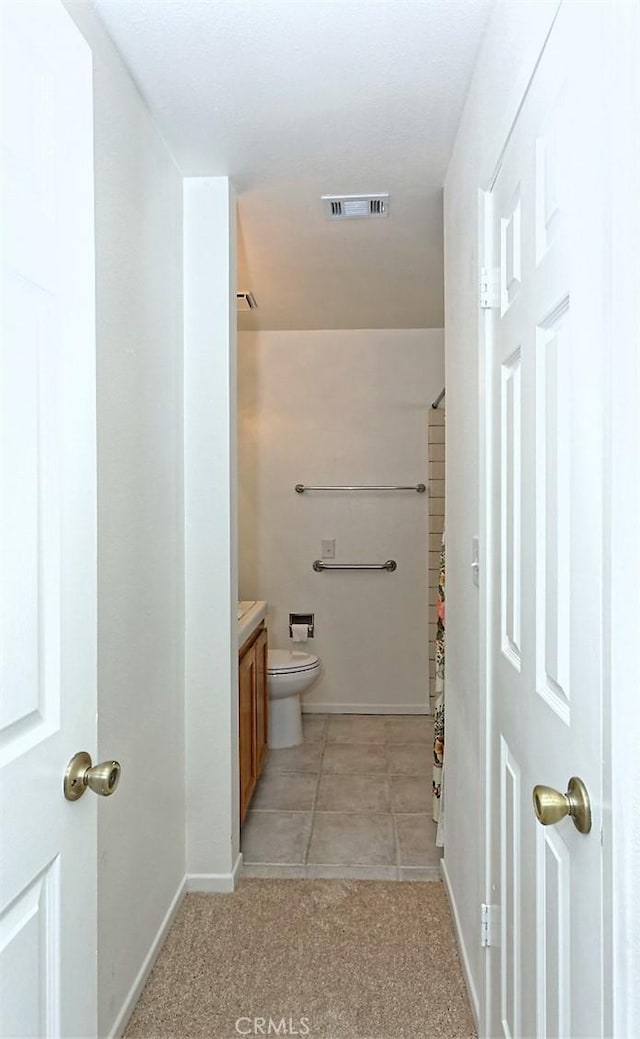 full bath featuring tile patterned floors, toilet, baseboards, visible vents, and vanity