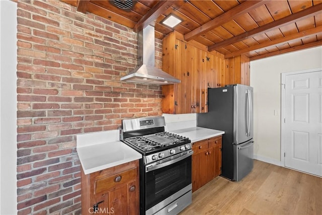 kitchen with stainless steel appliances, beam ceiling, wall chimney range hood, brown cabinetry, and wooden ceiling