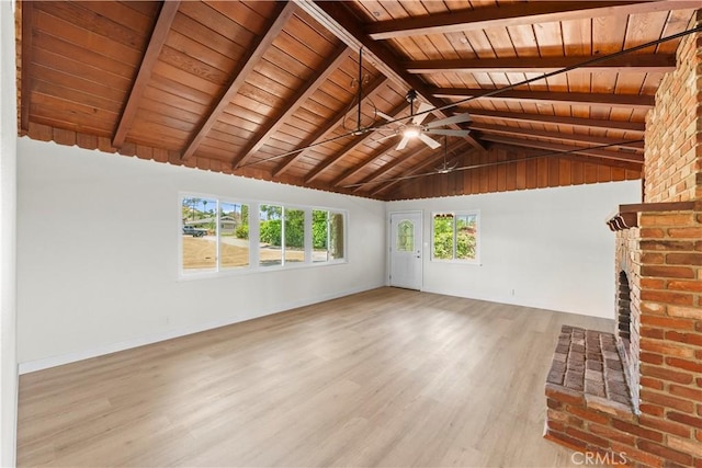 unfurnished living room with vaulted ceiling with beams, baseboards, a ceiling fan, wood finished floors, and wood ceiling