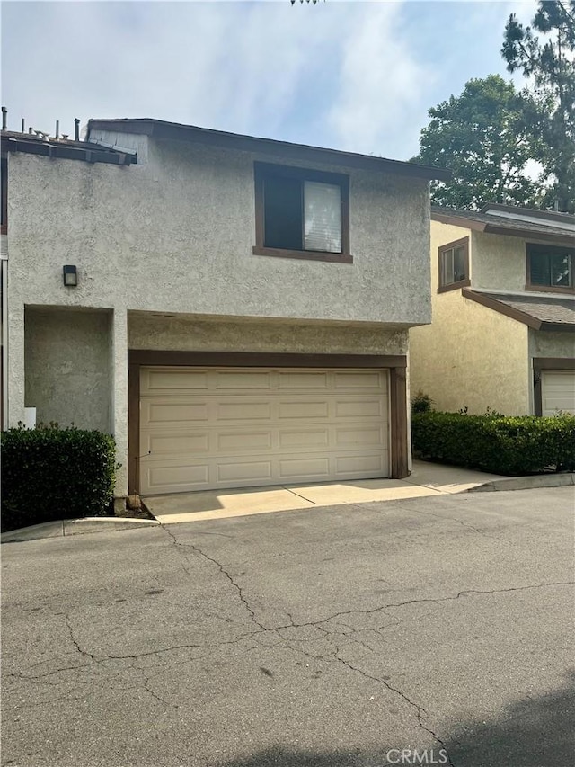 9330 Silverleaf Way, Rancho Cucamonga, CA 91701 - view of front of home featuring a garage, stucco siding, and driveway