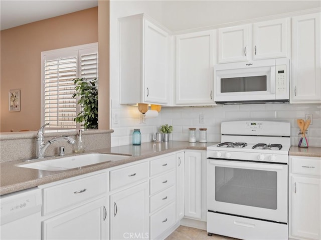kitchen with white cabinetry, tasteful backsplash, a sink, and white appliances