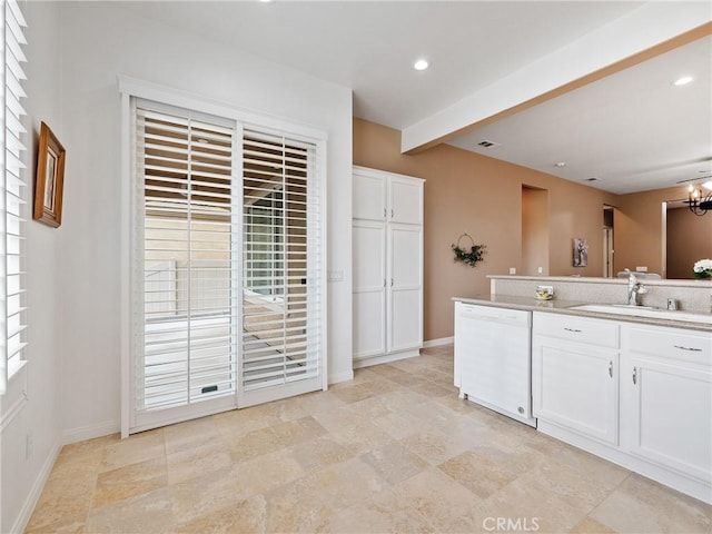 kitchen featuring light countertops, a sink, white dishwasher, baseboards, and white cabinetry