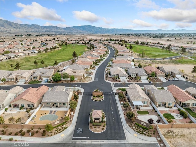 drone / aerial view with a mountain view, a residential view, and view of golf course