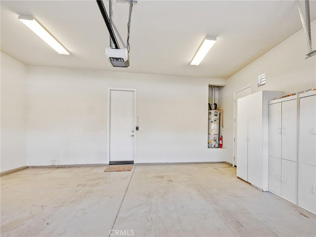 garage featuring water heater and a garage door opener