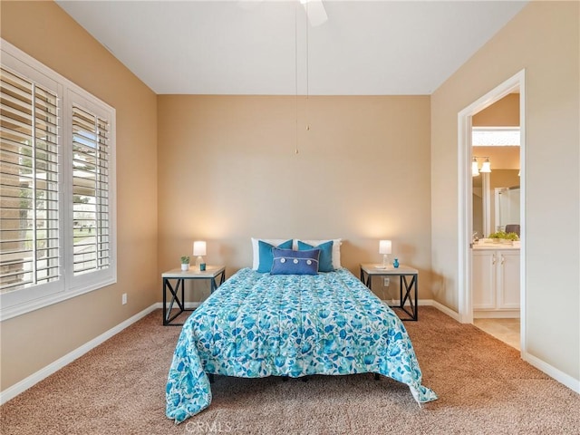 bedroom featuring connected bathroom, baseboards, a ceiling fan, and carpet flooring
