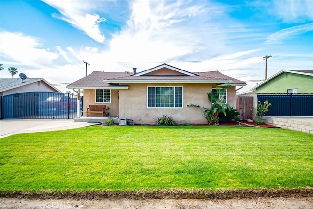 view of front facade featuring fence, a front lawn, a gate, and stucco siding