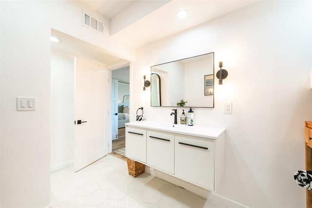 bathroom with tile patterned floors, vanity, baseboards, visible vents, and recessed lighting