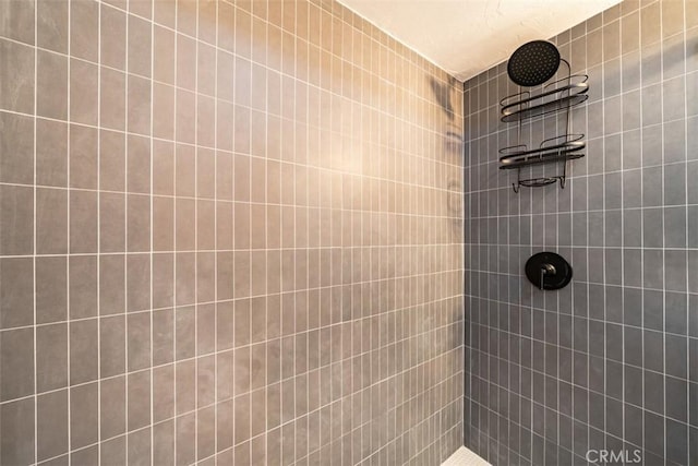 full bath with a tile shower