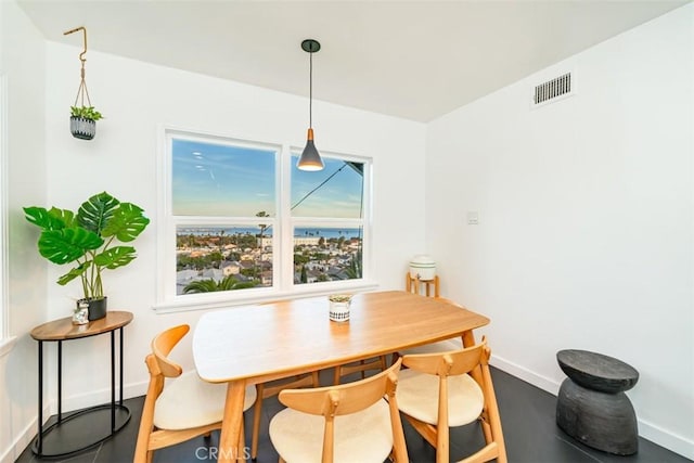 dining room with baseboards and visible vents