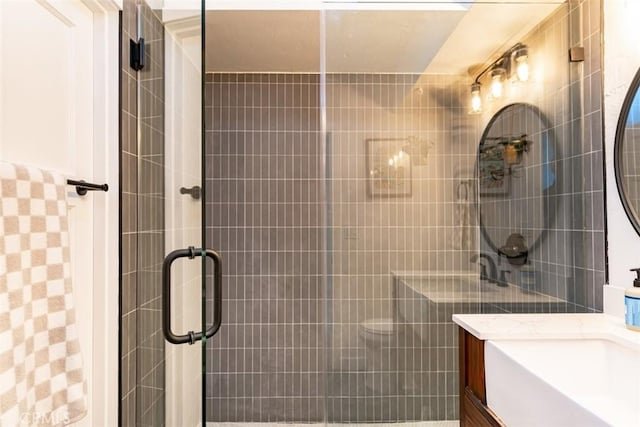 bathroom featuring a shower stall and vanity