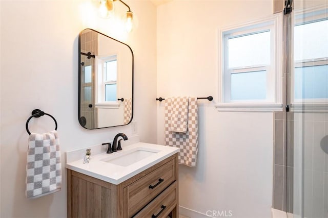 bathroom featuring a tile shower and vanity