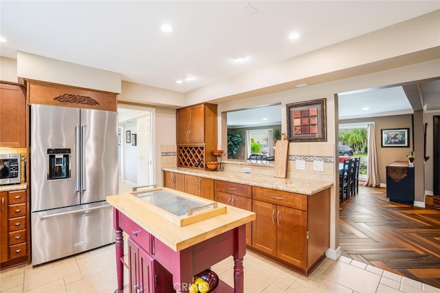 12843 Sarah St, Studio City, CA 91604 - kitchen with stainless steel appliances, decorative backsplash, brown cabinetry, and recessed lighting