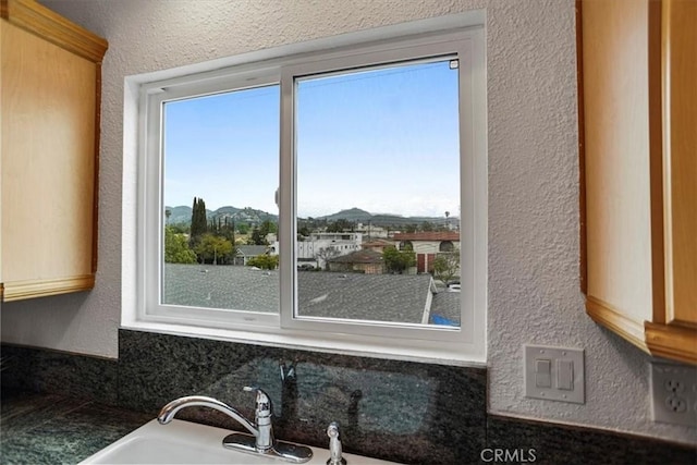 310 N Jackson St Unit 330, Glendale, CA 91206 - room details with dark countertops, a textured wall, and a mountain view