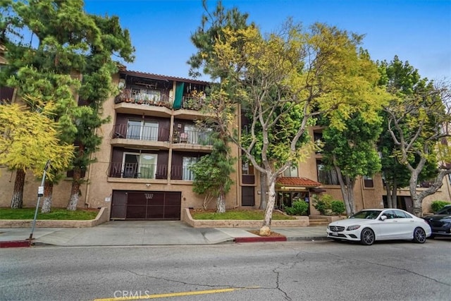 310 N Jackson St Unit 330, Glendale, CA 91206 - view of building exterior with an attached garage and driveway
