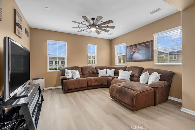 25889 Basil Ct, Corona, CA 92883 - living room featuring light wood-style flooring, a ceiling fan, and healthy amount of natural light