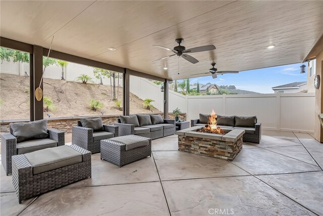 25889 Basil Ct, Corona, CA 92883 - view of patio with an outdoor living space with a fire pit, a fenced backyard, and a ceiling fan