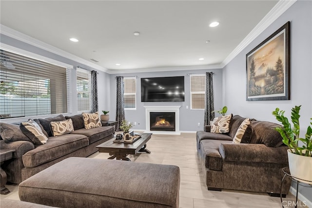 25889 Basil Ct, Corona, CA 92883 - living area with a glass covered fireplace, crown molding, recessed lighting, baseboards, and light wood-style flooring