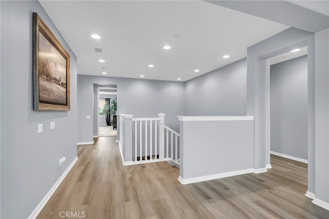 25889 Basil Ct, Corona, CA 92883 - hall with an upstairs landing, wood finished floors, baseboards, and recessed lighting