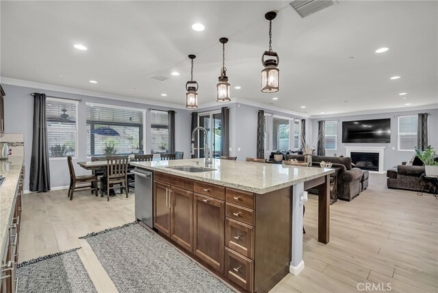 25889 Basil Ct, Corona, CA 92883 - kitchen featuring a sink, dishwasher, crown molding, a fireplace, and light wood finished floors