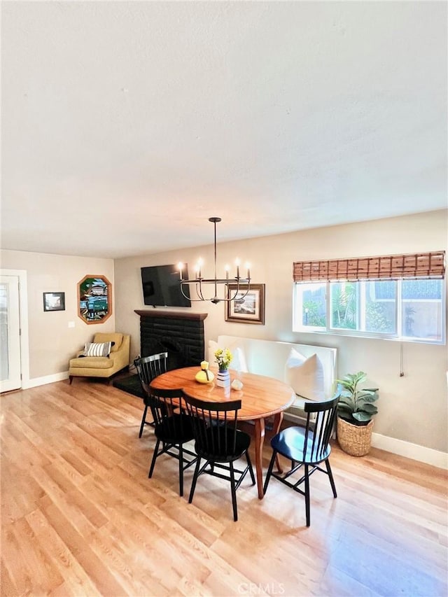 82 Avalon Terrace Rd, Avalon, CA 90704 - dining space featuring baseboards, a chandelier, and light wood-style flooring