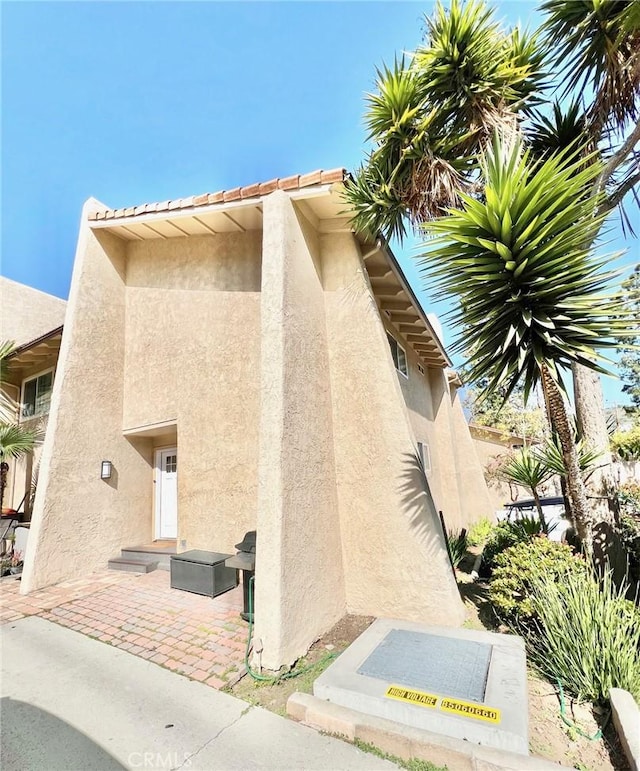 82 Avalon Terrace Rd, Avalon, CA 90704 - view of home's exterior with a patio and stucco siding