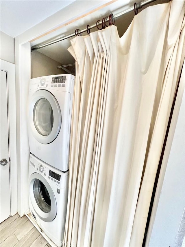 82 Avalon Terrace Rd, Avalon, CA 90704 - clothes washing area featuring light wood finished floors, stacked washer and dryer, and laundry area