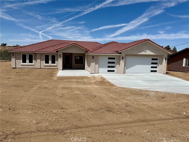 7452 Chase Ave, Hesperia, CA 92345 - view of front facade with a garage, stucco siding, driveway, and a tile roof