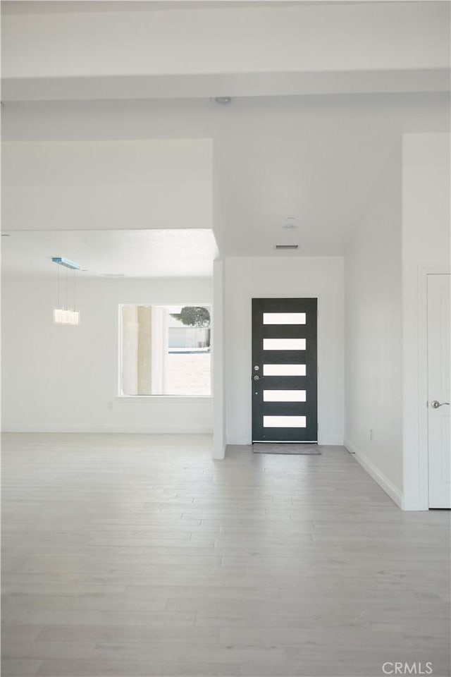 7452 Chase Ave, Hesperia, CA 92345 - foyer with light wood-style floors and baseboards