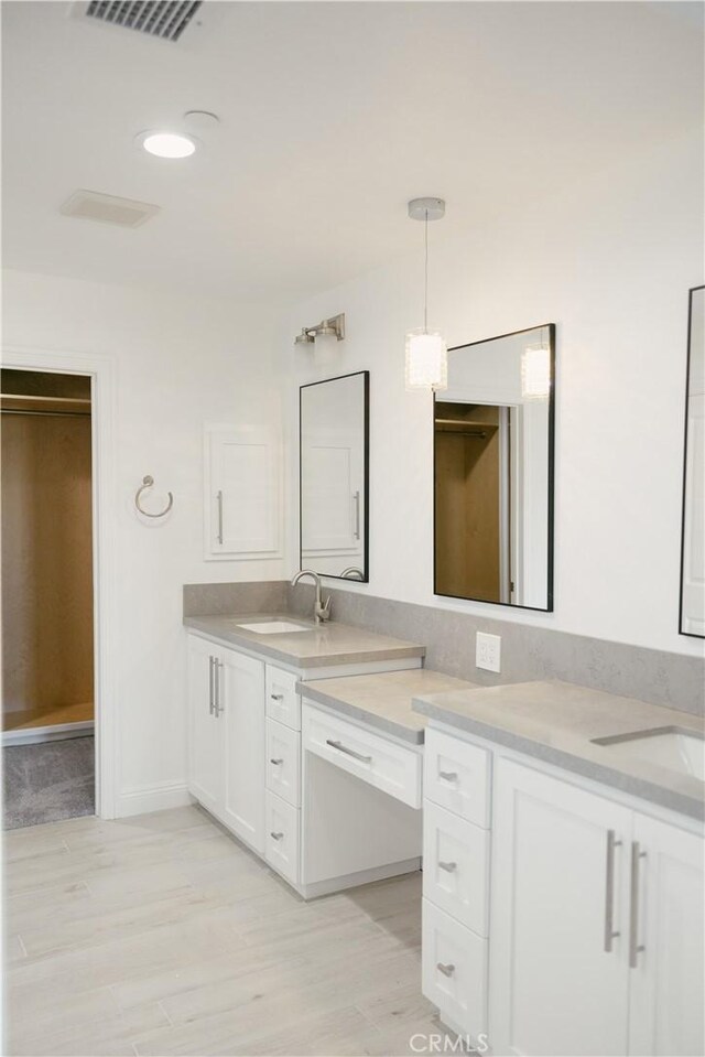 7452 Chase Ave, Hesperia, CA 92345 - bathroom featuring vanity, baseboards, and wood finished floors