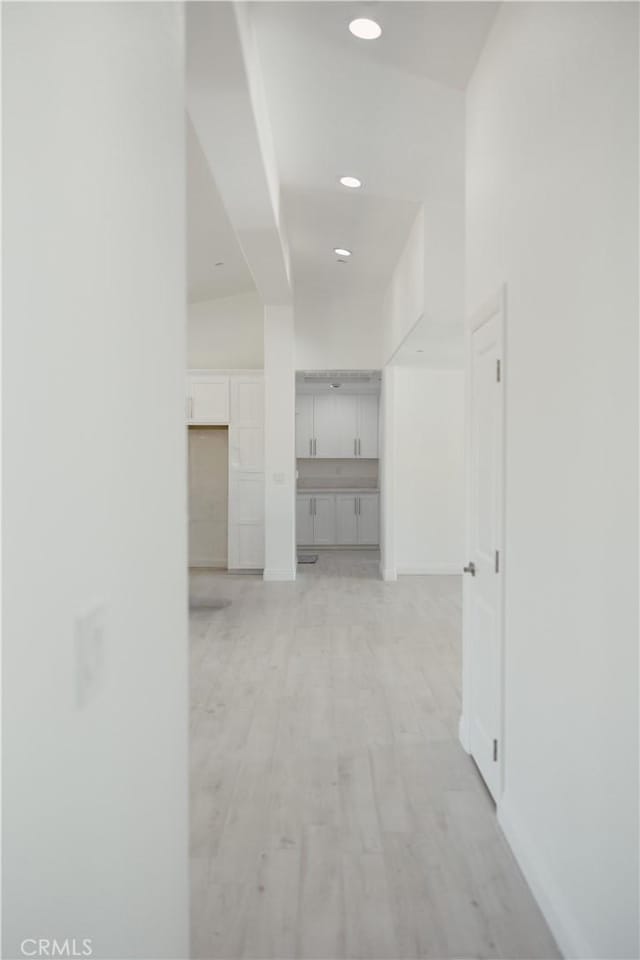 7452 Chase Ave, Hesperia, CA 92345 - hallway with baseboards, light wood-style flooring, and a towering ceiling