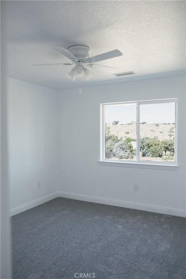 7452 Chase Ave, Hesperia, CA 92345 - spare room featuring dark carpet, baseboards, a ceiling fan, and a textured ceiling