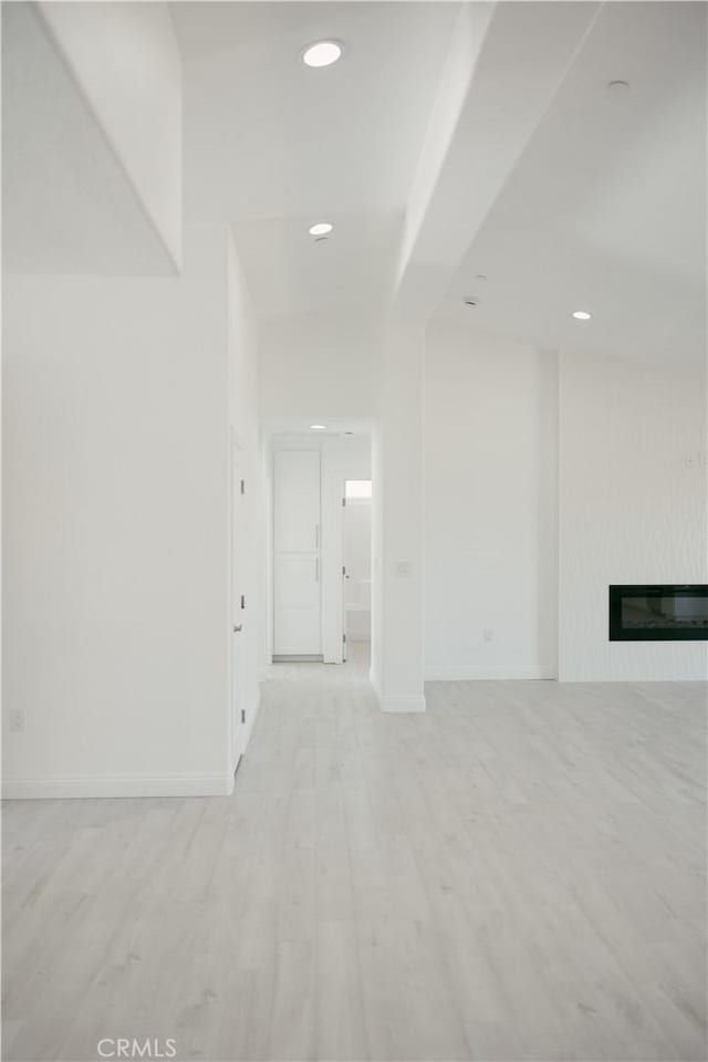 7452 Chase Ave, Hesperia, CA 92345 - unfurnished living room featuring wood finished floors, recessed lighting, a glass covered fireplace, and baseboards