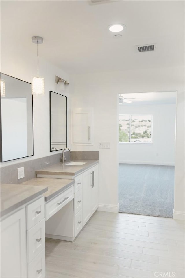 7452 Chase Ave, Hesperia, CA 92345 - bathroom featuring vanity, baseboards, wood finished floors, and recessed lighting