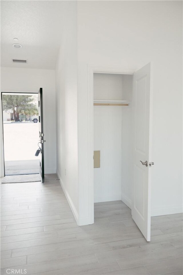 7452 Chase Ave, Hesperia, CA 92345 - corridor featuring light wood finished floors and baseboards