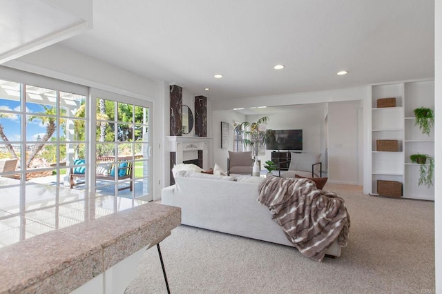 living area with recessed lighting, carpet floors, and a fireplace