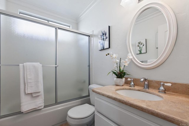bathroom with combined bath / shower with glass door, vanity, ornamental molding, and toilet
