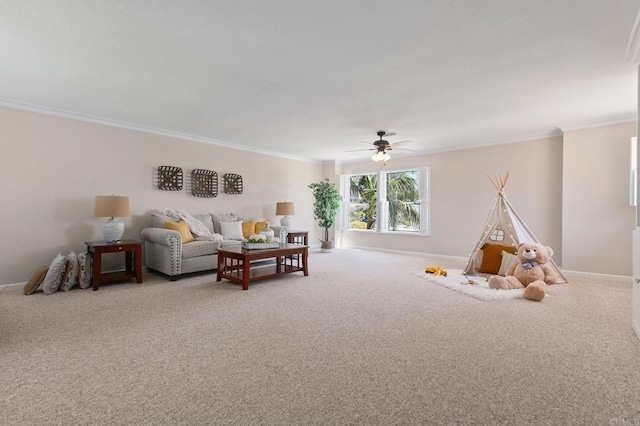 living room featuring a ceiling fan, baseboards, carpet, and ornamental molding