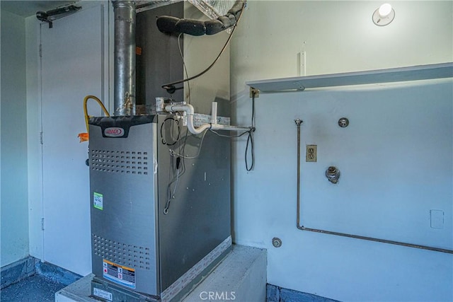 utility room featuring heating unit