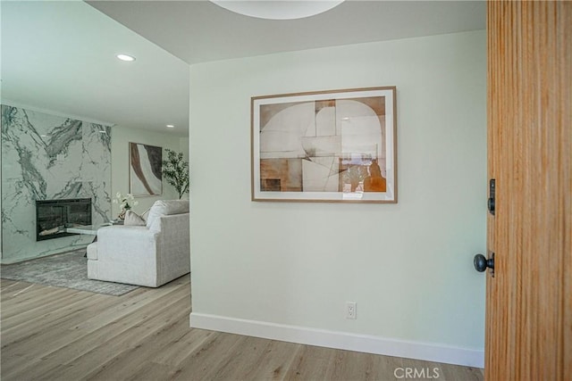 hallway with baseboards, wood finished floors, and recessed lighting