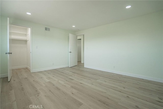 unfurnished bedroom with baseboards, recessed lighting, and light wood-style flooring