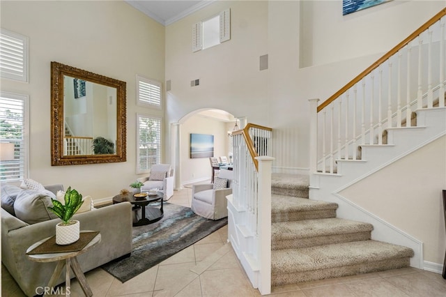 20904 Parkside, Lake Forest, CA 92630 - staircase featuring arched walkways, tile patterned flooring, a high ceiling, ornamental molding, and healthy amount of natural light