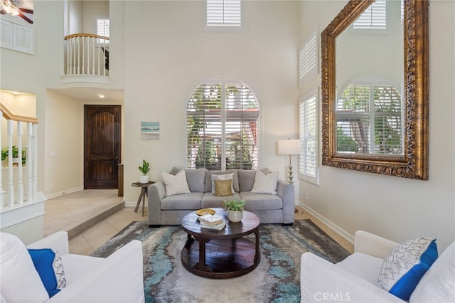 20904 Parkside, Lake Forest, CA 92630 - tiled living room with a towering ceiling, baseboards, healthy amount of natural light, and a ceiling fan