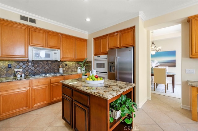 20904 Parkside, Lake Forest, CA 92630 - kitchen featuring white appliances, a chandelier, light tile patterned floors, decorative backsplash, and brown cabinets