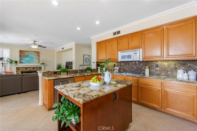 20904 Parkside, Lake Forest, CA 92630 - kitchen with stainless steel appliances, light tile patterned flooring, a peninsula, a ceiling fan, and crown molding