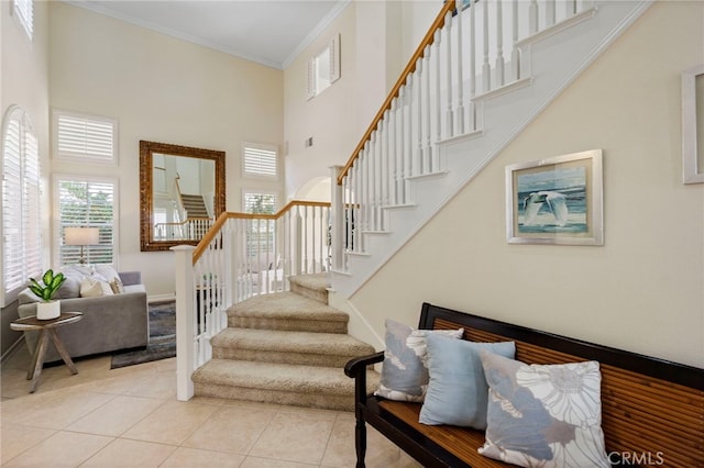 20904 Parkside, Lake Forest, CA 92630 - stairs featuring a towering ceiling, tile patterned flooring, and ornamental molding