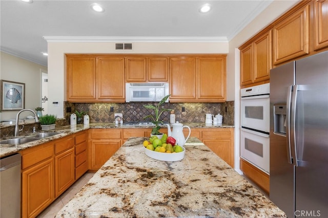 20904 Parkside, Lake Forest, CA 92630 - kitchen featuring stainless steel appliances, a sink, ornamental molding, light stone counters, and recessed lighting