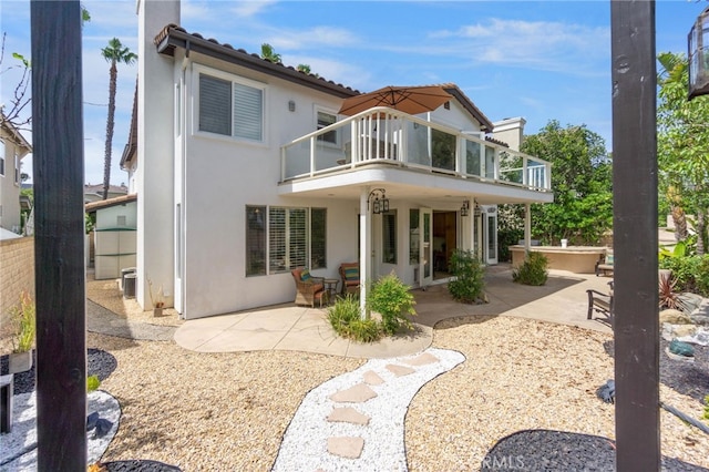 20904 Parkside, Lake Forest, CA 92630 - rear view of house featuring a balcony, stucco siding, a patio, and fence