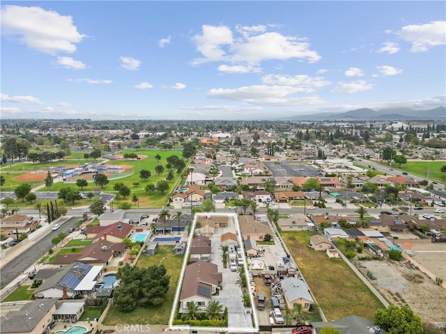 9614 Cypress Ave, Fontana, CA 92335 - aerial view of property and surrounding area featuring property parcel outlined, a mountain backdrop, and nearby suburban area